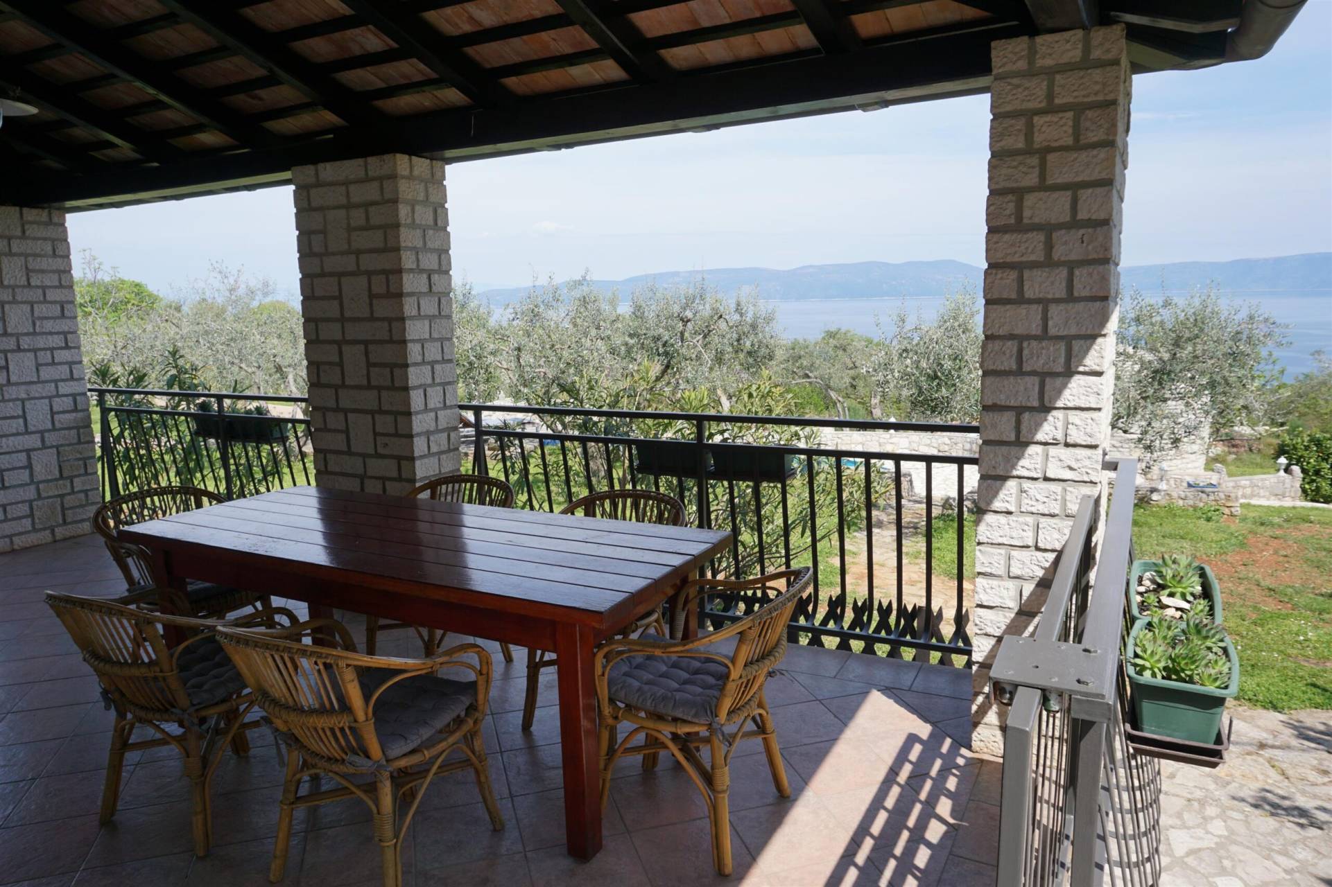 A view from the terrace with wooden table and chairs