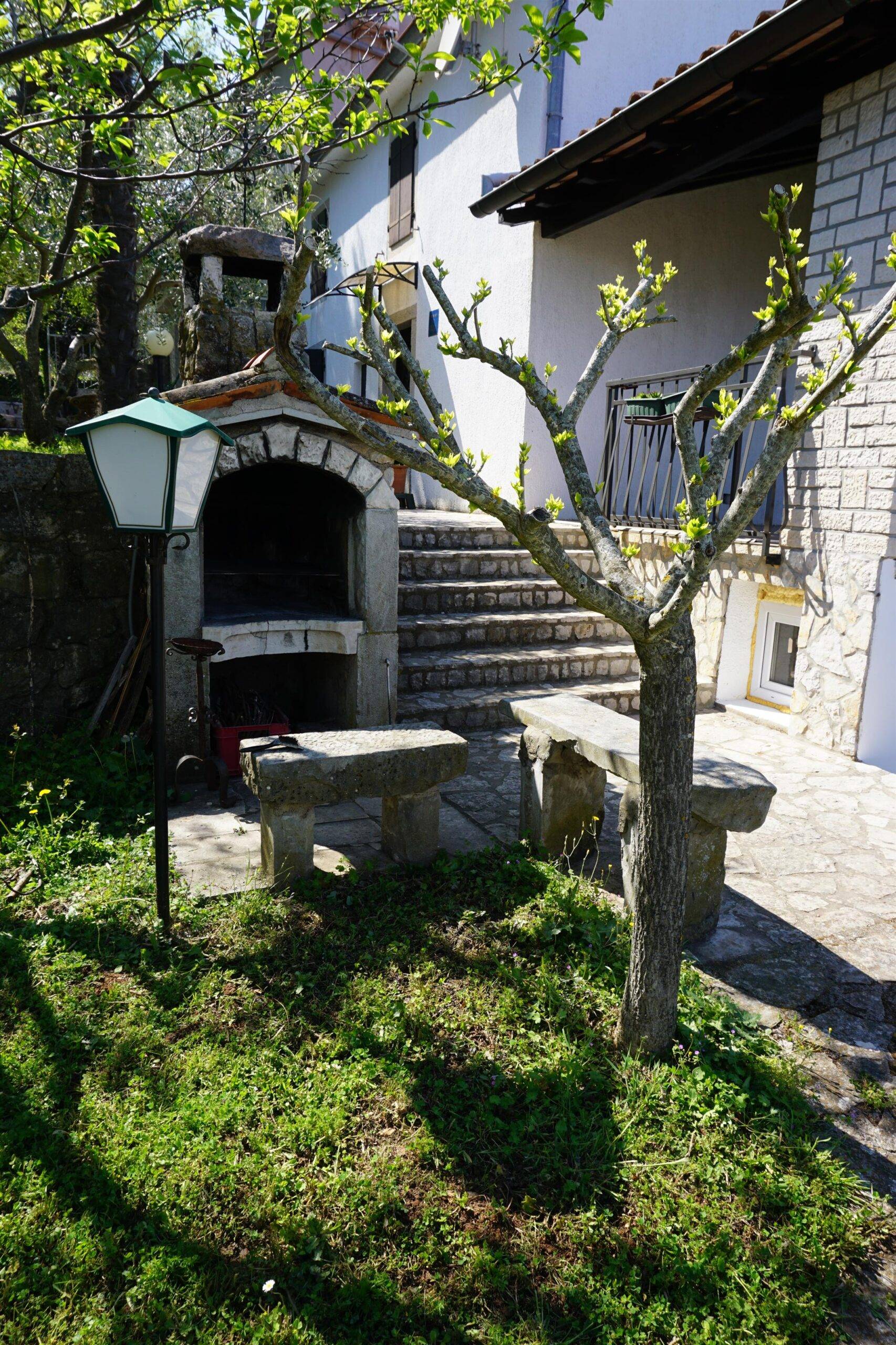Fireplace with stone benches on the front entrance of the house