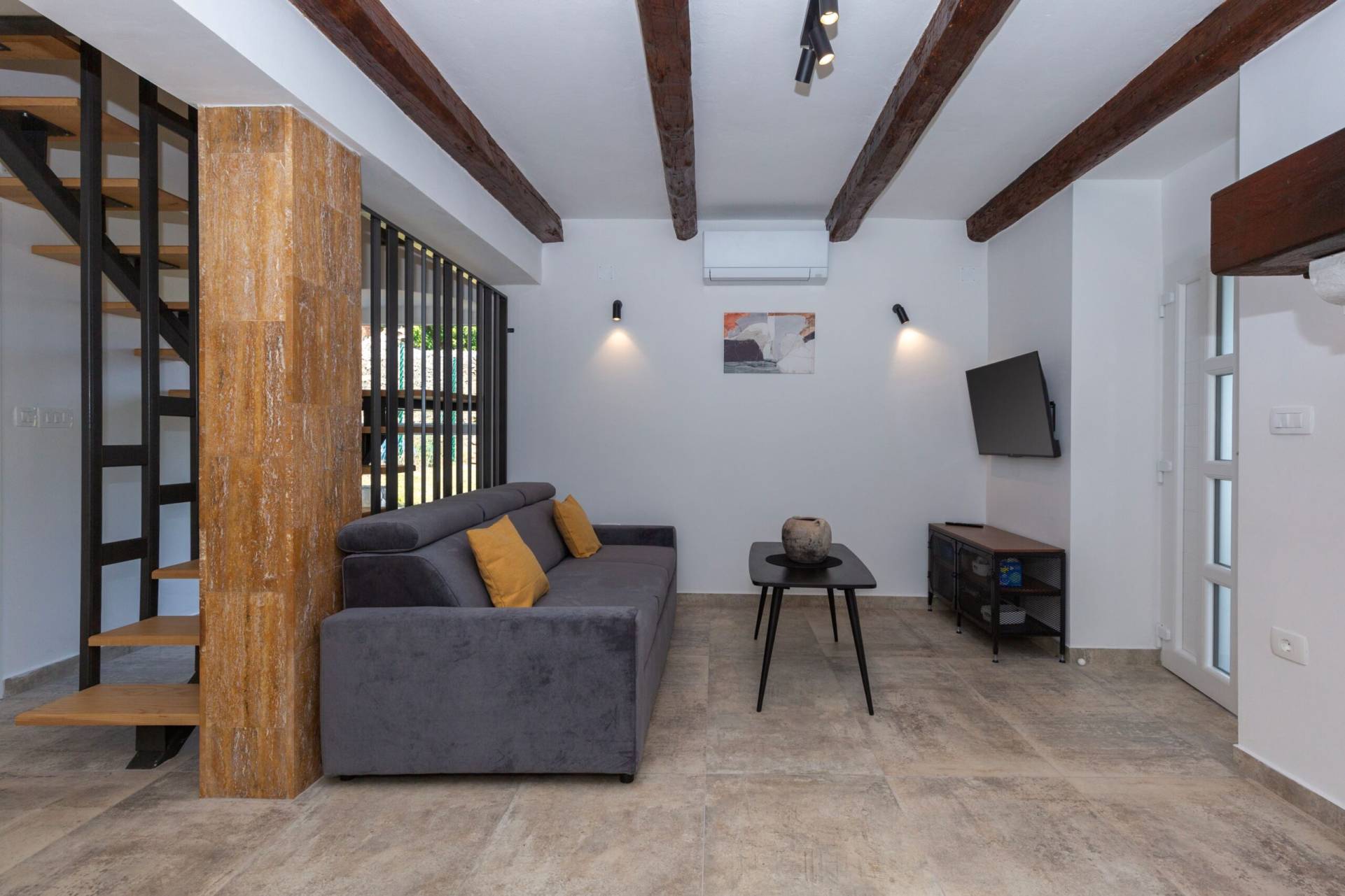 A side view of the living room with staird behind