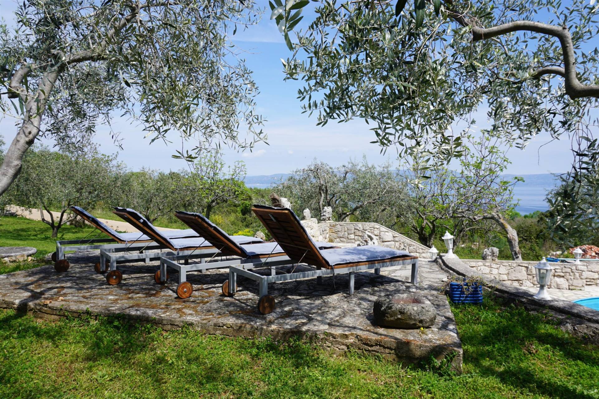 Four comfortable beach chairs next to the pool