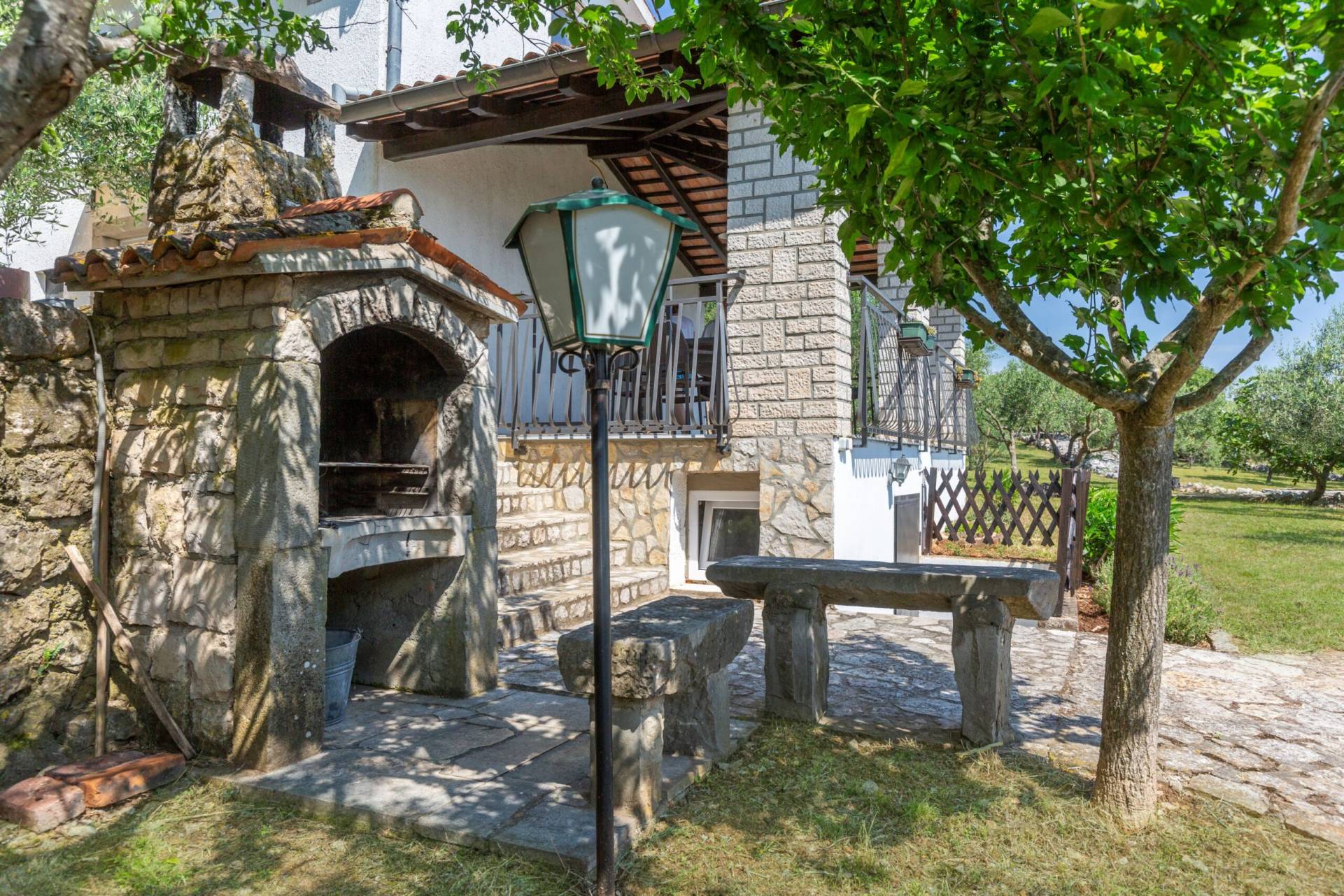Fireplace with stone benches on the side of the house